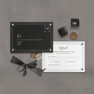 Wedding stationery flatlay of black and white celestial RSVP card designed by The Little Paper Shop