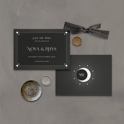 Wedding stationery flatlay of black Aurora celestial save the date card designed by The Little Paper Shop
