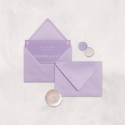 Wedding stationery flatlay with invitation inside a lilac envelope designed by The Little Paper Shop