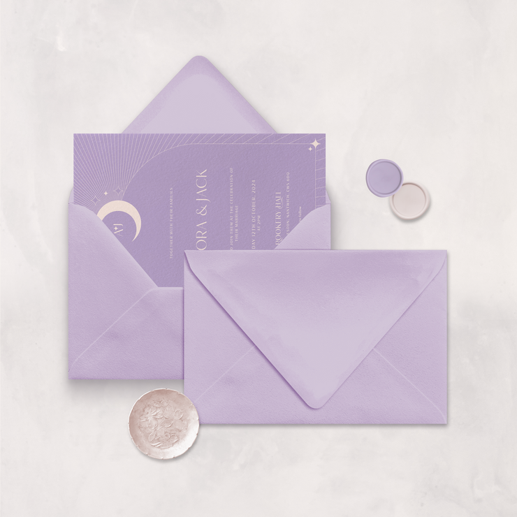 Wedding stationery flatlay with invitation inside a lilac envelope designed by The Little Paper Shop