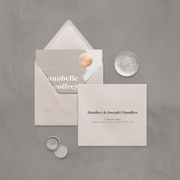 Wedding stationery flatlay with printed address on neutral coloured envelope designed by The Little Paper Shop