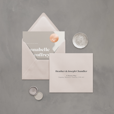 Wedding stationery flatlay with printed address on neutral coloured envelope designed by The Little Paper Shop