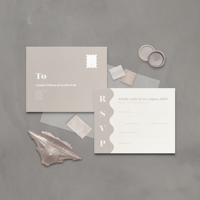 Flatlay of wavy neutral coloured wedding stationery RSVP postcard designed by The Little Paper Shop