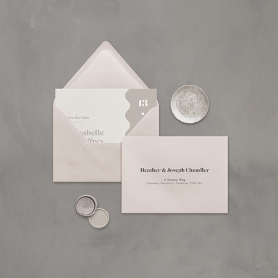 Wedding stationery flatlay with printed address on neutral envelope designed by The Little Paper Shop