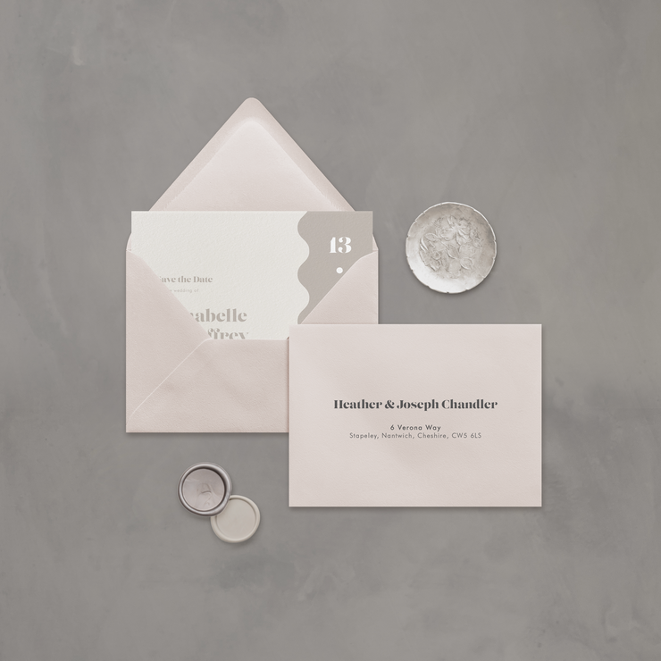 Wedding stationery flatlay with printed address on neutral envelope designed by The Little Paper Shop