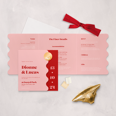 Pink and red Wedding stationery flatlay with wavy edge designed by The Little Paper Shop