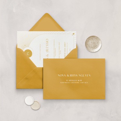 Wedding stationery flatlay with printed address on a mustard envelope designed by The Little Paper Shop