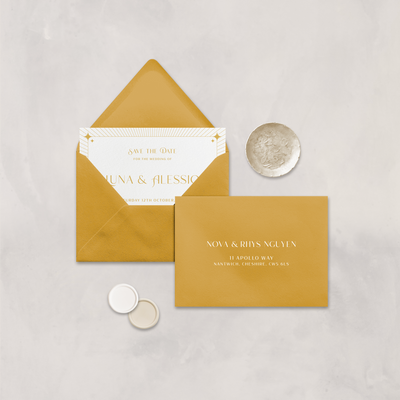 Wedding stationery flatlay with printed address on a mustard envelope designed by The Little Paper Shop