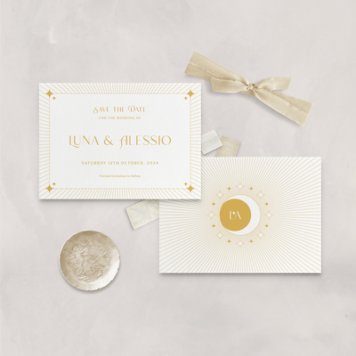 Wedding stationery flatlay of white and mustard Aurora celestial save the date card designed by The Little Paper Shop