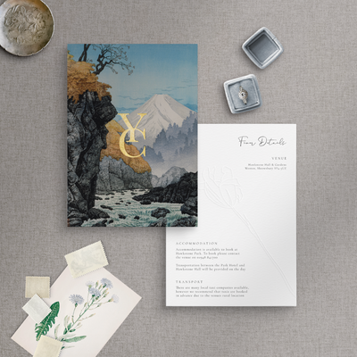 Gold foiled monogram on mountain wedding invitation flatlay on rose embossed information card - designed by The Little Paper Shop