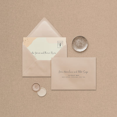 Wedding stationery flatlay including printed address envelope upgrade designed by The Little Paper Shop